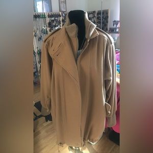 Wool woman’s coat. 100% Wool also sweater material around neck/bottom sleeves.